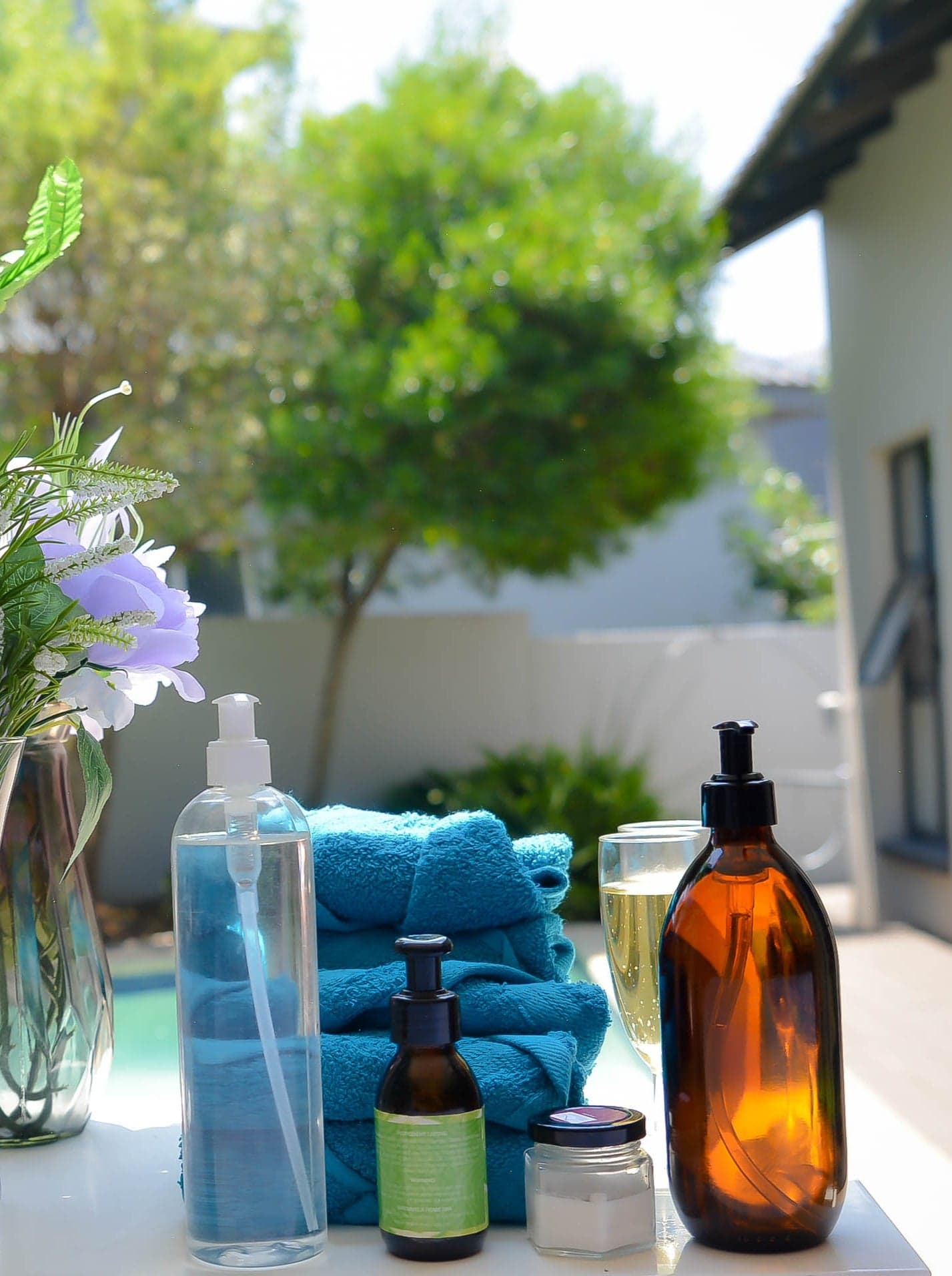 Serenity Well mobile spa setup — oils and towels in a garden setting